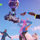 Fortnite characters dance outside under a cloudy blue sky.